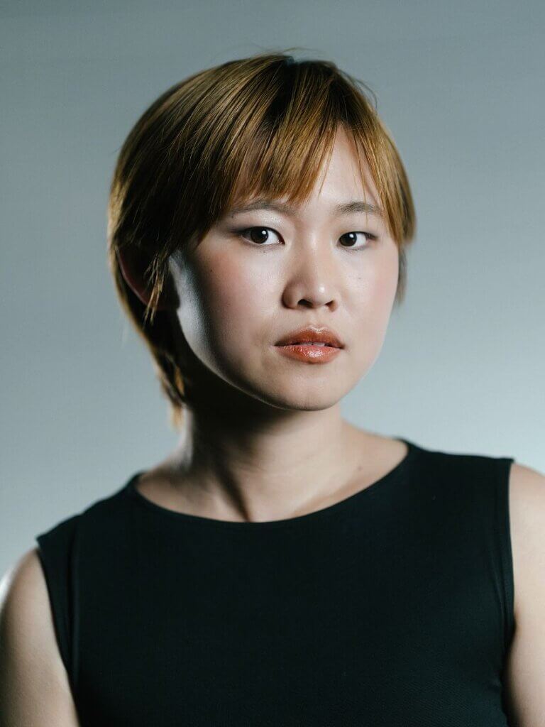 Young woman looking confidently at the camera, highlighting empowerment and diversity in nonprofit initiatives.