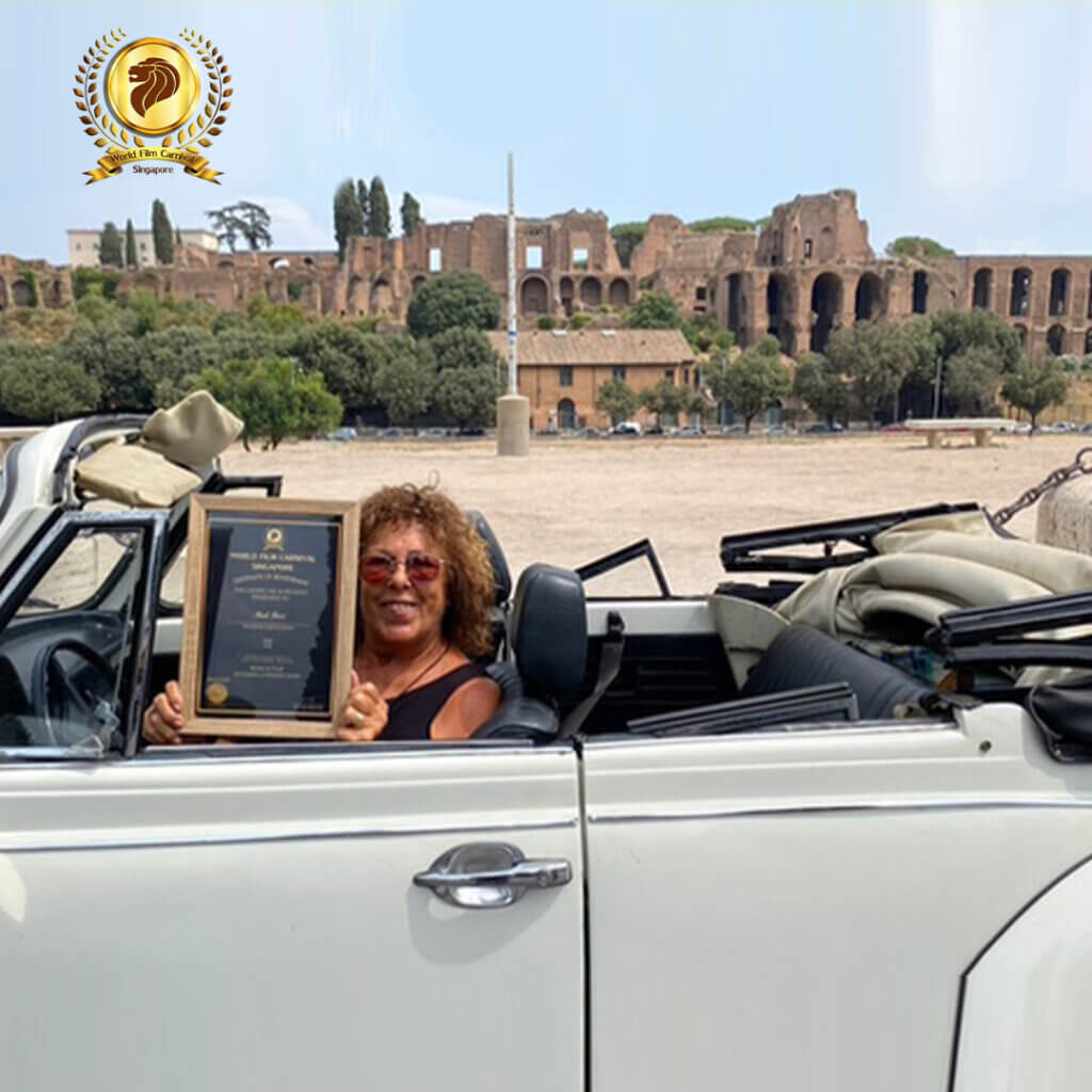 Smiling woman in a convertible holds an award, symbolizing achievement and belonging against a historic backdrop.